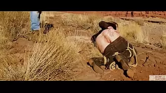 Enormous-behind blonde gets her butthole whipped, then gets rough anal sex in dirt and piss -- a real BDSM session outdoors in the Western USA with Rebel Rhyder